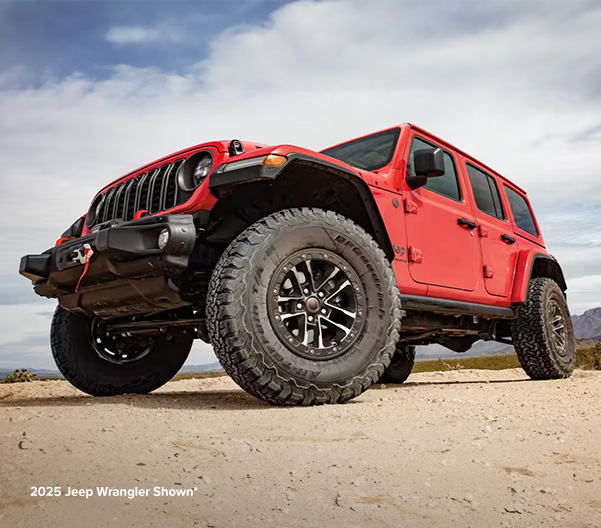 Shot of Jeep Wrangler parked on sand