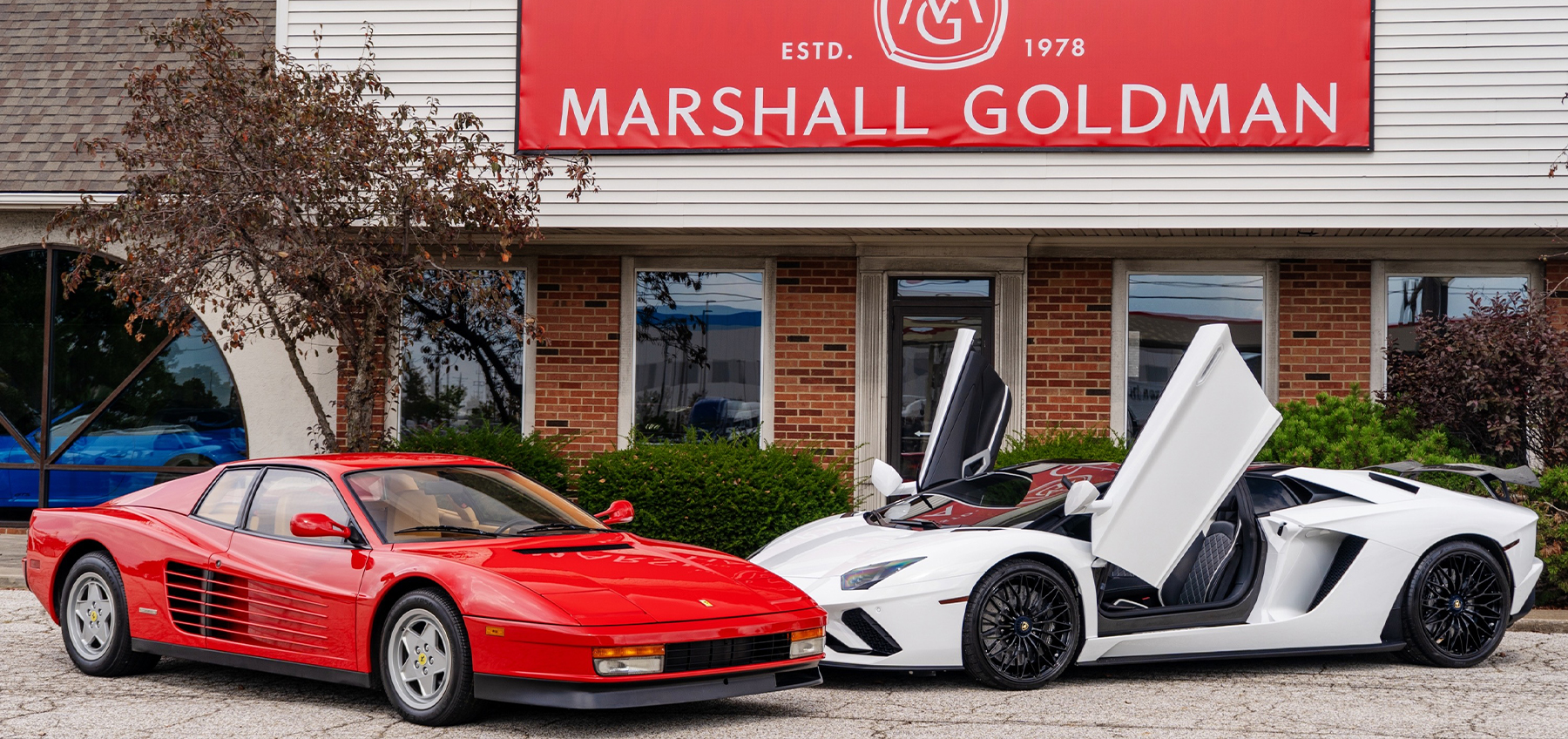 Dealership employee showing a couple a vehicle in the showroom