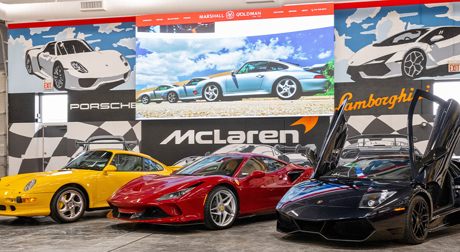 Dealership employee pointing to finance paperwork