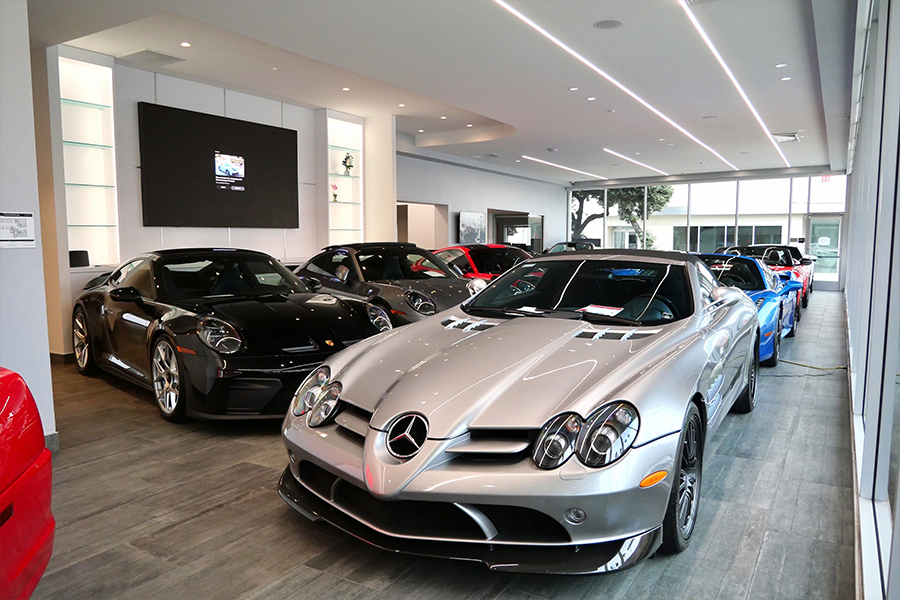 Dealership employee handing a clipboard to the customer with keys on it