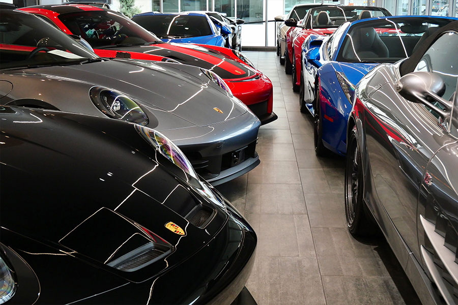 Person on their computer in the dealership with a calculator beside it