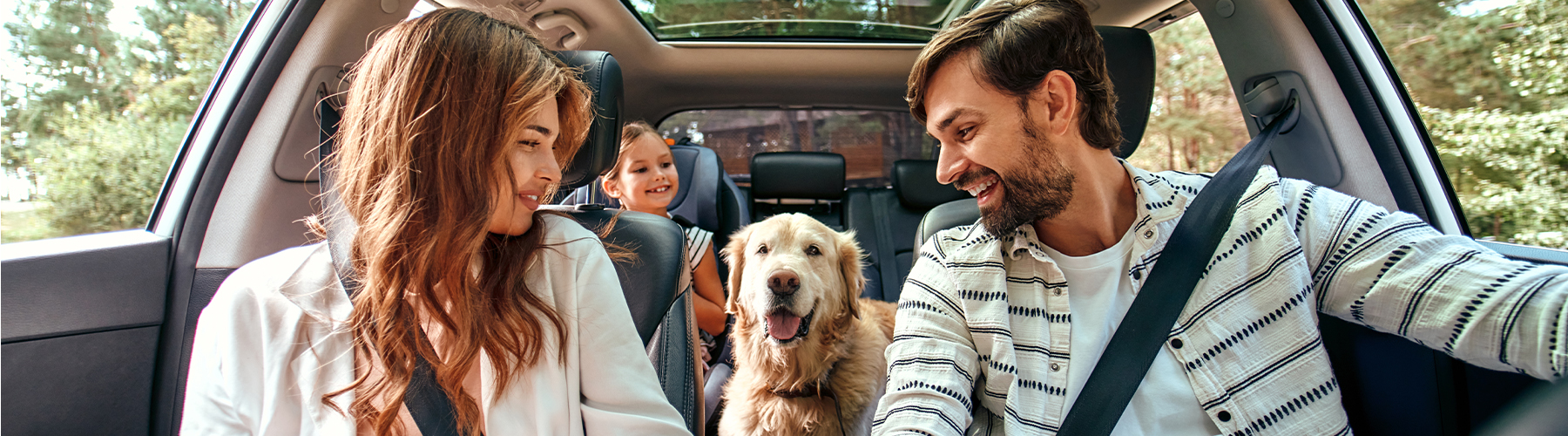 Happy family driving in car