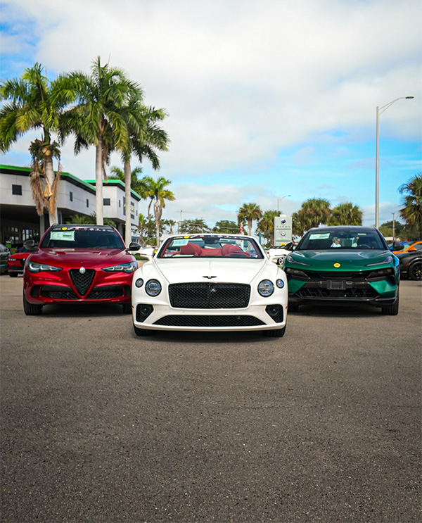 Three Luxury Cars parked outside the dealership