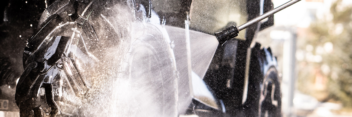 Up close shot of someone power washing ATV wheels