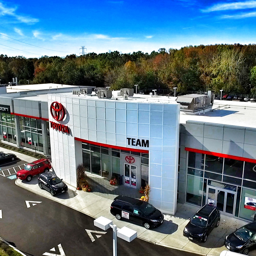 Dealership lot with cars parked in front