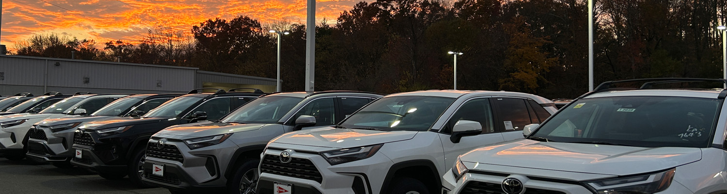 Lineup of Toyota cars outside of dealership