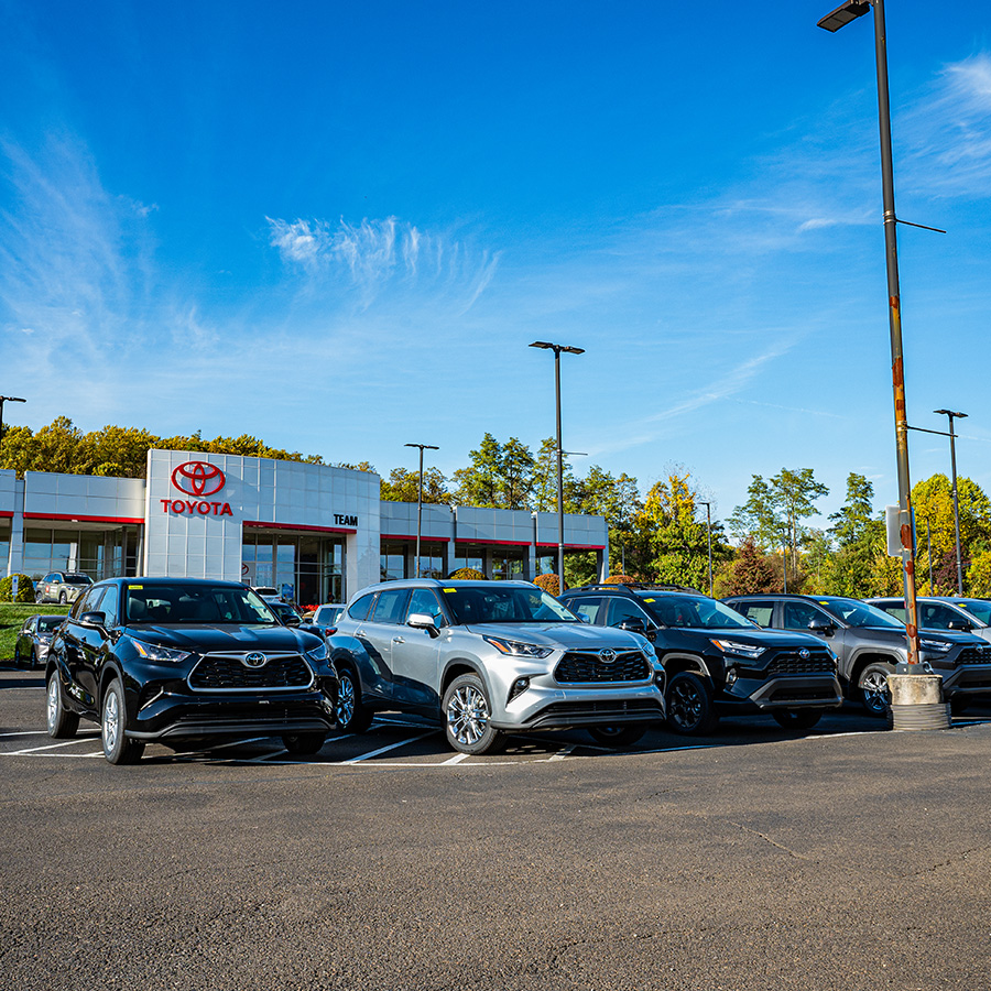 Dealership lot with cars parked in front