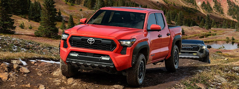 Front view of a 2025 Toyota Tacoma i-FORCE MAX parked on a mountain terrain