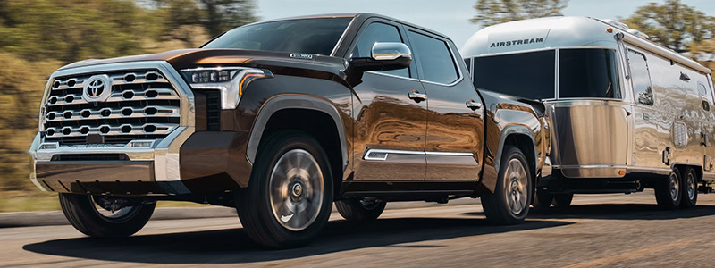 2025 Toyota Tundra i-FORCE MAX towing an RV on the road