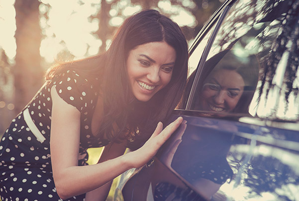 Woman inspecting a new car